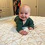 Grayson joined the competition — help win amazing prizes! baby, smiling, bed, quilt, green_clothing, indoor, portrait, child, face, person, hand, blue_eyes, furniture, room, door, clothes, closet, happy, skin, head