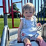 toddler, child, slide, playground, outdoor, sunny, smiling, blue_sky, grass, metal, pink_socks, bows, romper, shorts, happy, person, daylight, park, fence, play_equipment