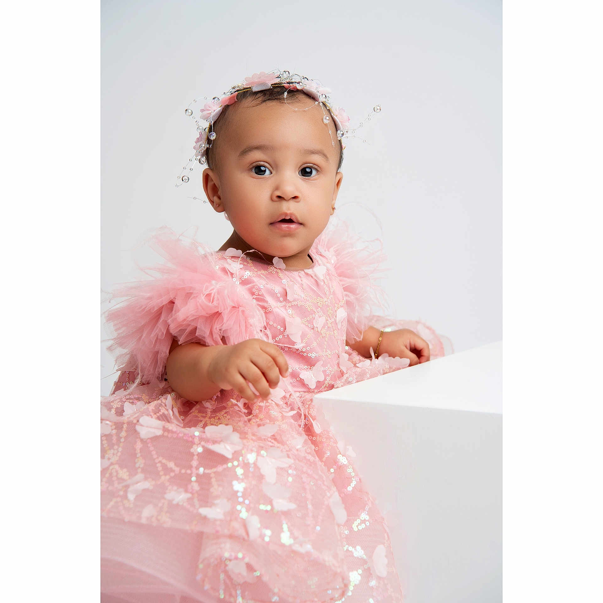 Zoe is registered to the contest to win money with this photo: accessories, baby, bodypart, bonnet, clothing, doll, dress, eveningdress, face, fashion, featherboa, finger, formalwear, hand, hat, head, person, photography, portrait, toy