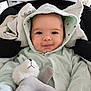 baby, infant, hooded_suit, car_seat, stuffed_animal, toy, smile, eyes, face, chubby_cheeks, blanket, cozy, indoor, portrait, soft_toy, mint_green, clothing, adorable, seat, closeup