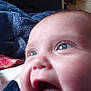 Ivy is registered to the contest to win money with this photo: baby, close_up, smile, blue_eyes, joy, indoor, blanket, couch, face, child, infant, happy, expression, person, head, mouth, tongue, clothing, cheeks, skin