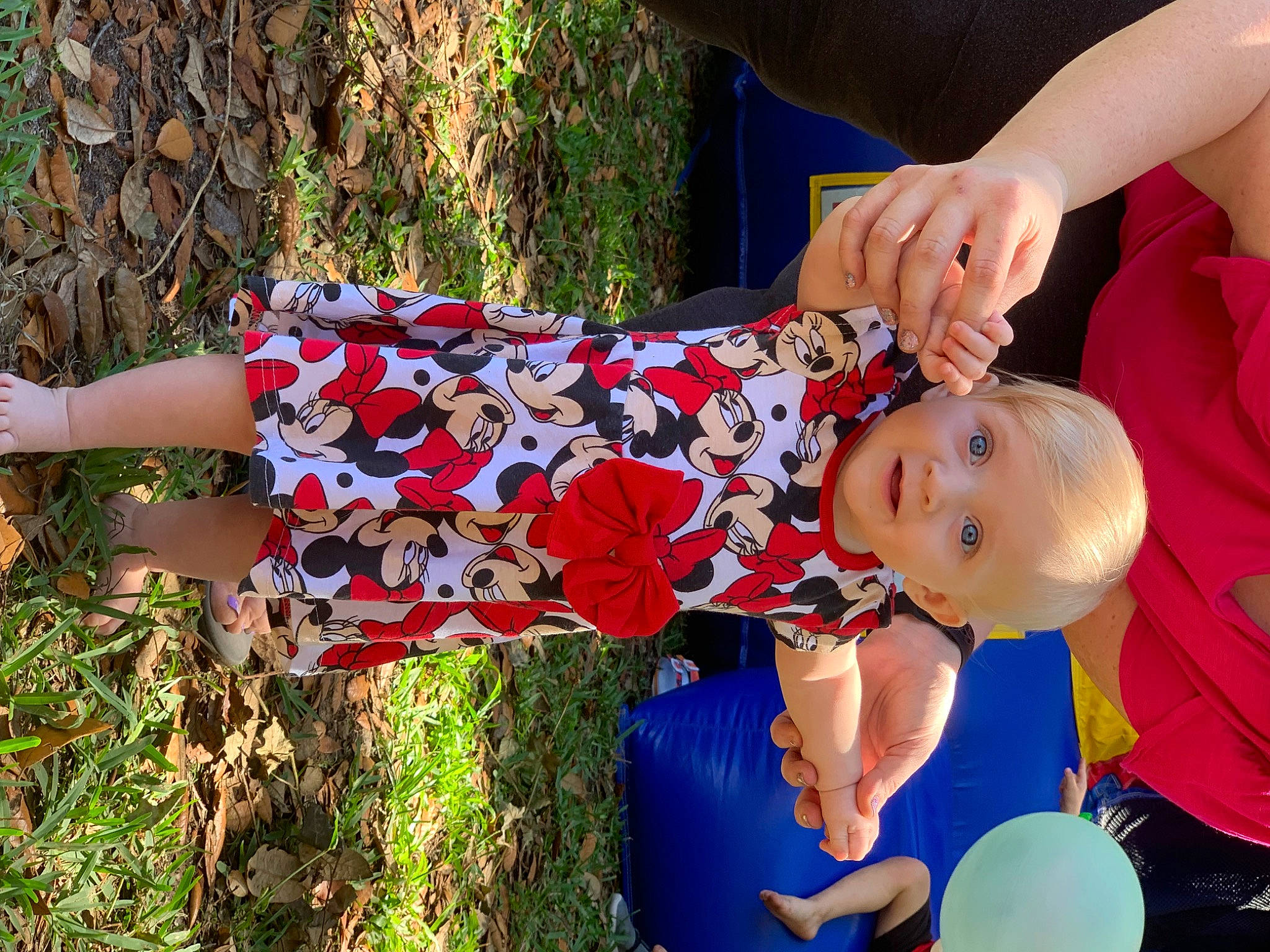 Laine is registered to the contest to win money with this photo: baby, baby_toddler_clothing, balloon, child, clothing, electric_blue, event, fun, grass, happy, human_leg, leisure, pattern, people_in_nature, person, plant, red, sitting, spring, toddler