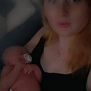 Nora joined the competition — help win amazing prizes! woman, baby, newborn, pacifier, holding, portrait, indoor, dim_light, soft_focus, person, skin, face, hand, necklace, clothing, mother, child, sleeping, caring, family