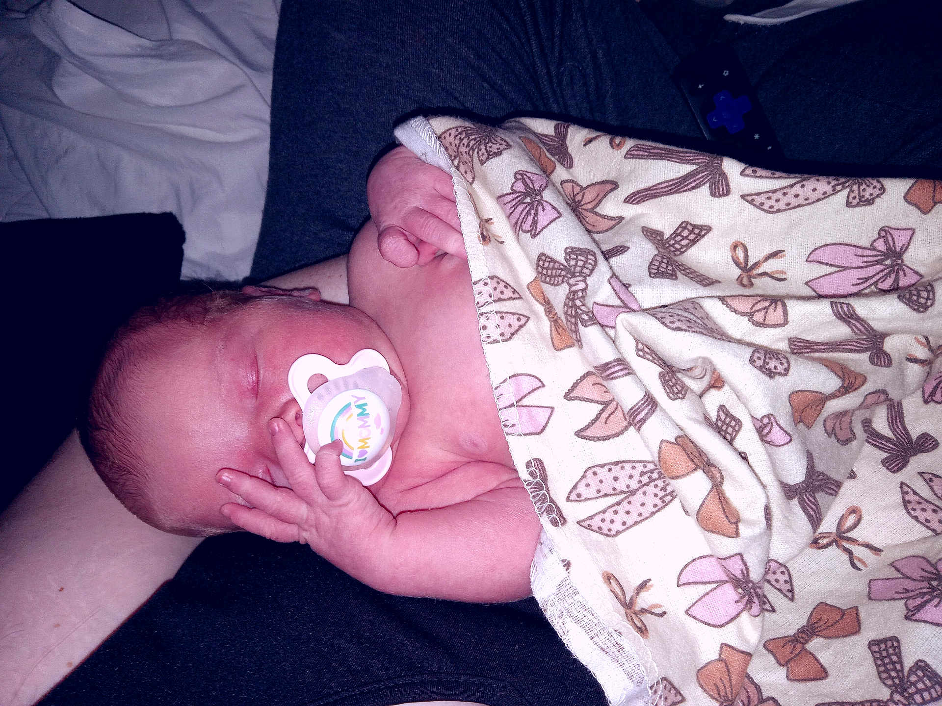 Nora joined the competition — help win amazing prizes! newborn, baby, pacifier, blanket, sleeping, infant, hand, person, clothing, pattern, bow, resting, comfort, skin, human, closeup, relaxation, indoors, nap, soft