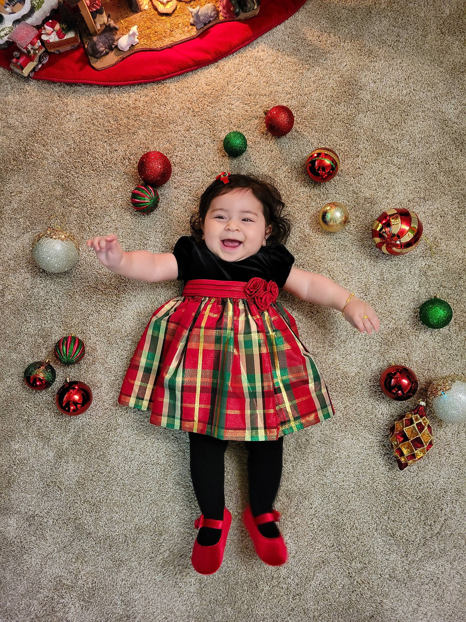 Daniela joined the competition — help win amazing prizes! christmas, christmas_decoration, christmas_ornament, dress, facial_expression, happy, holiday_ornament, human_body, joy, ornament, person, plaid, plant, red, sleeve, smile, sock, standing, tartan, textile
