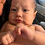 Micheal is registered to the contest to win money with this photo: baby, infant, face, hand, skin, expression, furrowed_brow, pursed_lips, closeup, person, indoor, couch, diaper, fist, motion_blur, newborn, child, portrait, human, baby_skin