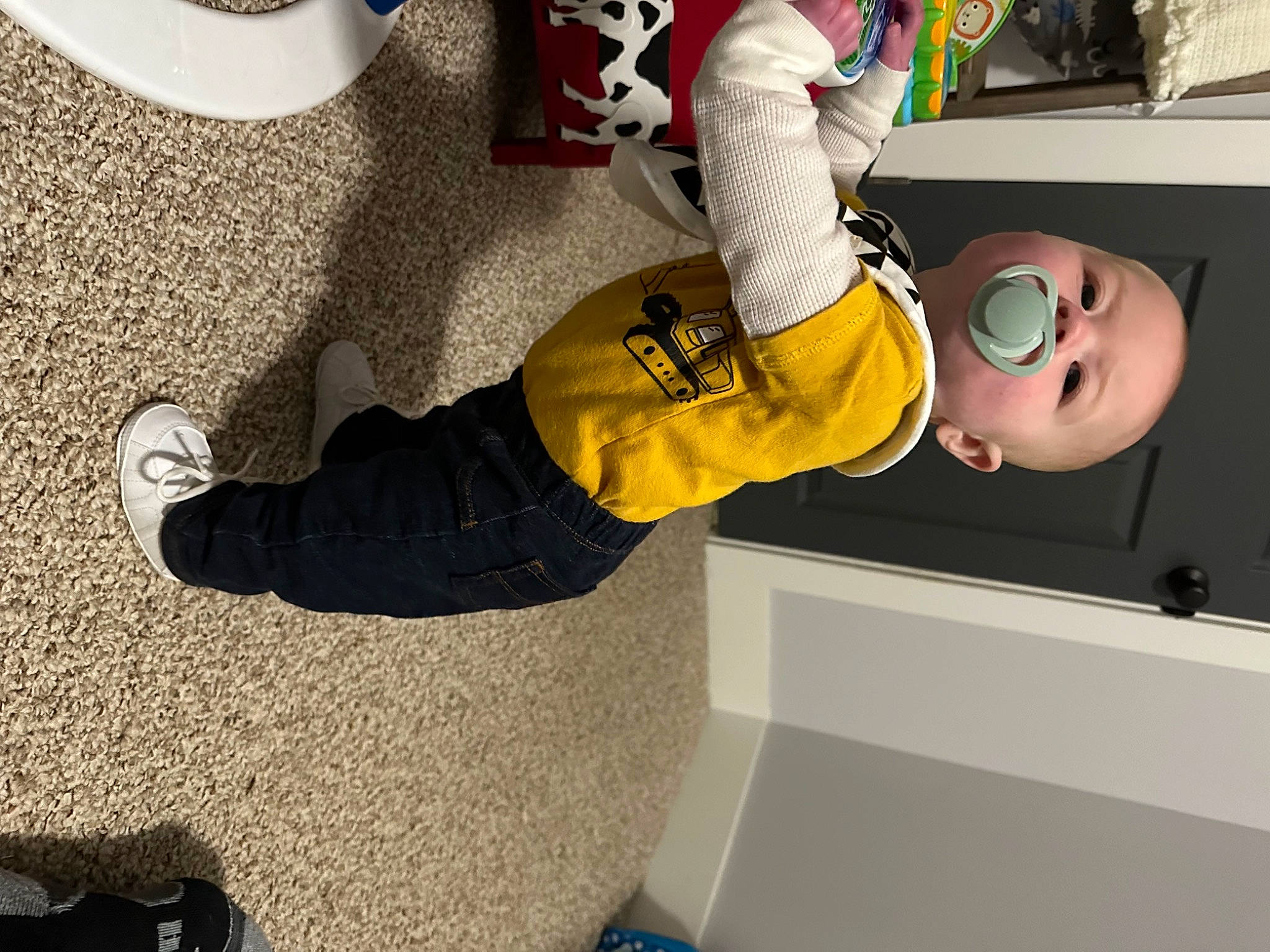 Carter is registered to the contest to win money with this photo: ankle, carmine, child, comfort, flooring, foot, fun, human_leg, knee, machine, outdoor_shoe, person, personal_protective_equipment, room, sneakers, sock, sportswear, thigh, walking_shoe, white