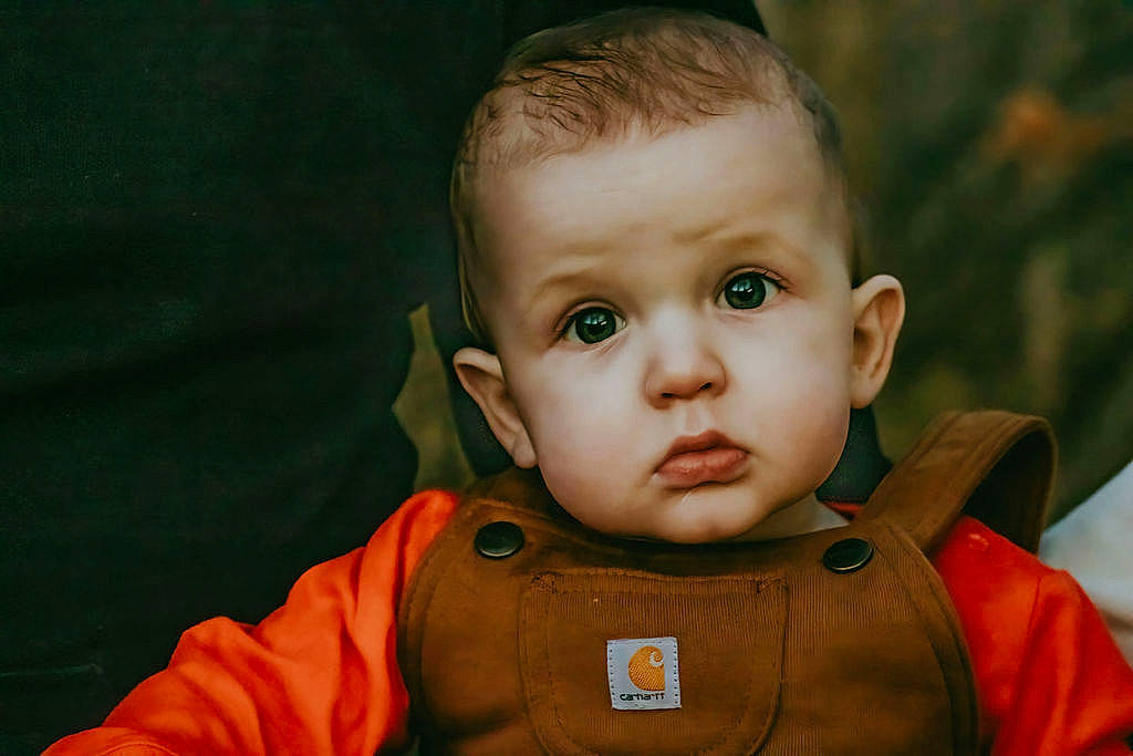 Brayden is registered to the contest to win money with this photo: baby, cheek, eye, eyelash, face, flash_photography, forehead, gesture, grass, happy, head, human_body, iris, jacket, lip, mouth, nose, person, skin, sleeve