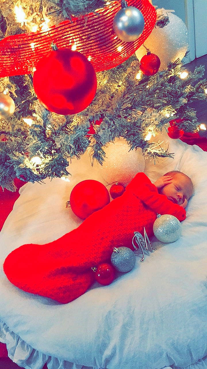 Makena is registered to the contest to win money with this photo: christmas, christmas_decoration, christmas_eve, christmas_ornament, christmas_tree, fictional_character, fir, interior_design, person, pine_family, red, tree