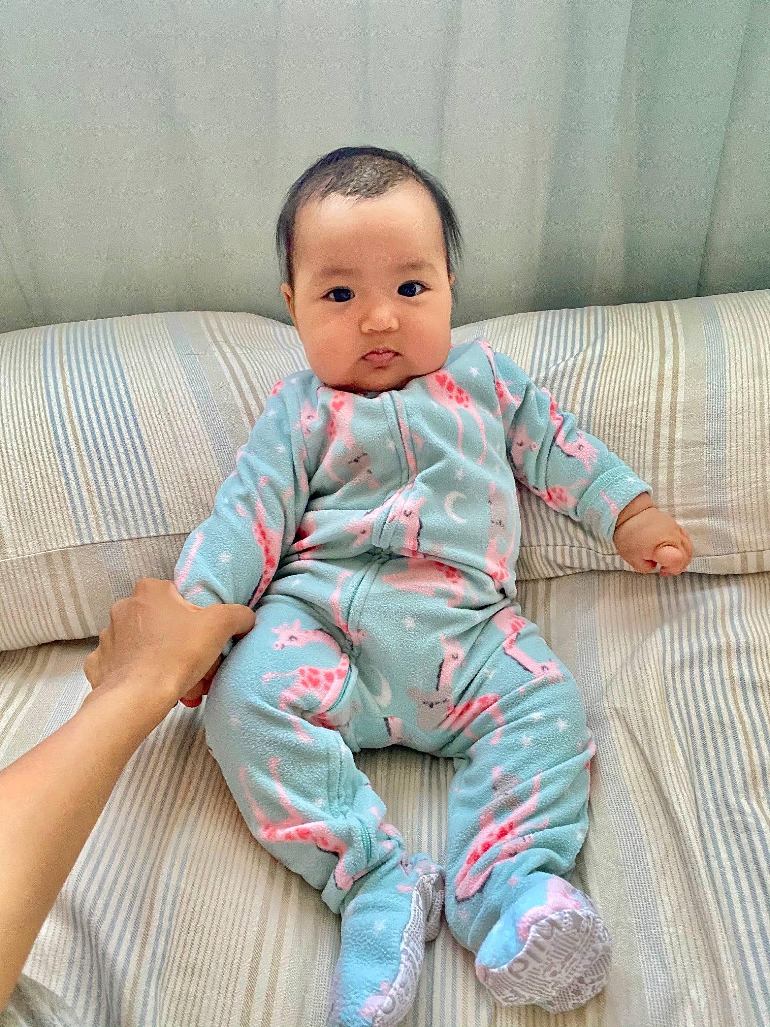 Deborah is registered to the contest to win money with this photo: baby, baby_toddler_clothing, child, comfort, couch, ear, finger, foot, linens, living_room, nightwear, person, pillow, pink, sitting, slipcover, sock, textile, throw_pillow, toddler