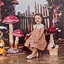 Taliah joined the competition — help win amazing prizes! child, girl, dress, mushrooms, flowers, duck_statue, umbrella, garden, fairy_tale, seated, smiling, wooden_fence, playful, decorative, props, indoor_scene, portrait, cute, colorful, fantasy