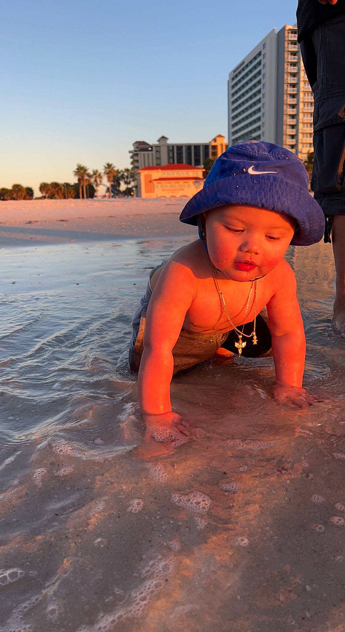 Amoni joined the competition — help win amazing prizes! beach, body_of_water, coast, freezing, fun, headwear, horizon, landscape, leisure, orange, people_on_beach, person, personal_protective_equipment, reflection, sand, shore, sky, sunlight, toddler, tree
