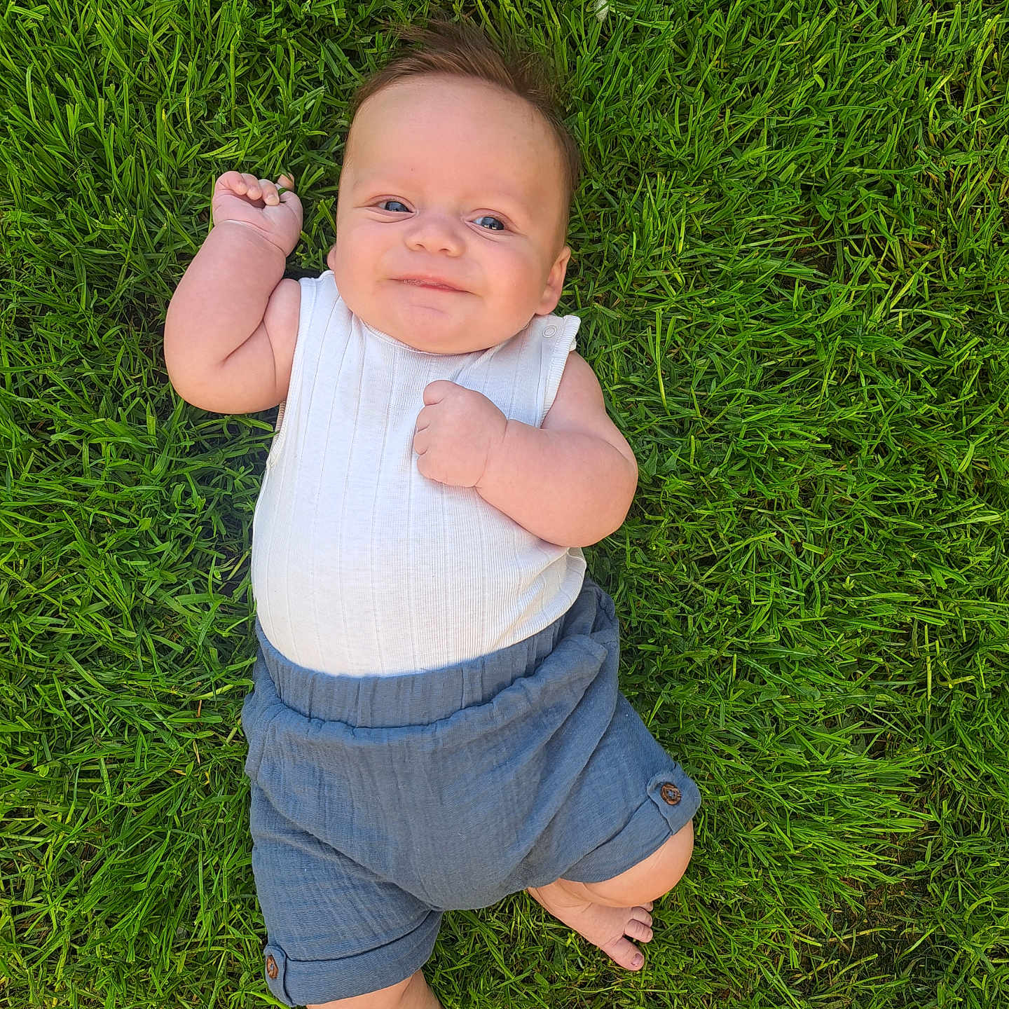 Cody joined the competition — help win amazing prizes! baby, barefoot, child, clothing, cute, daylight, grass, greenery, happy, infant, lying_down, nature, outdoor, person, portrait, relaxed, shorts, smile, summer, white_top