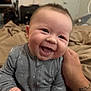 Rayden joined the competition — help win amazing prizes! baby, bed, blanket, child, clothing, cozy, cute, expression, face, hand, happy, indoor, infant, joyful, onesie, person, portrait, smiling, tattoo, young