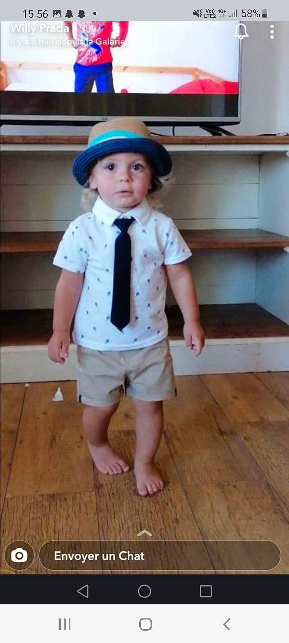 Liam participe au concours pour gagner de l'argent avec cette photo : baby_toddler_clothing, barefoot, child, collar, dress_shirt, flooring, hardwood, hat, headgear, headwear, knee, outerwear, pattern, person, sleeve, standing, street_fashion, sun_hat, toddler, waist