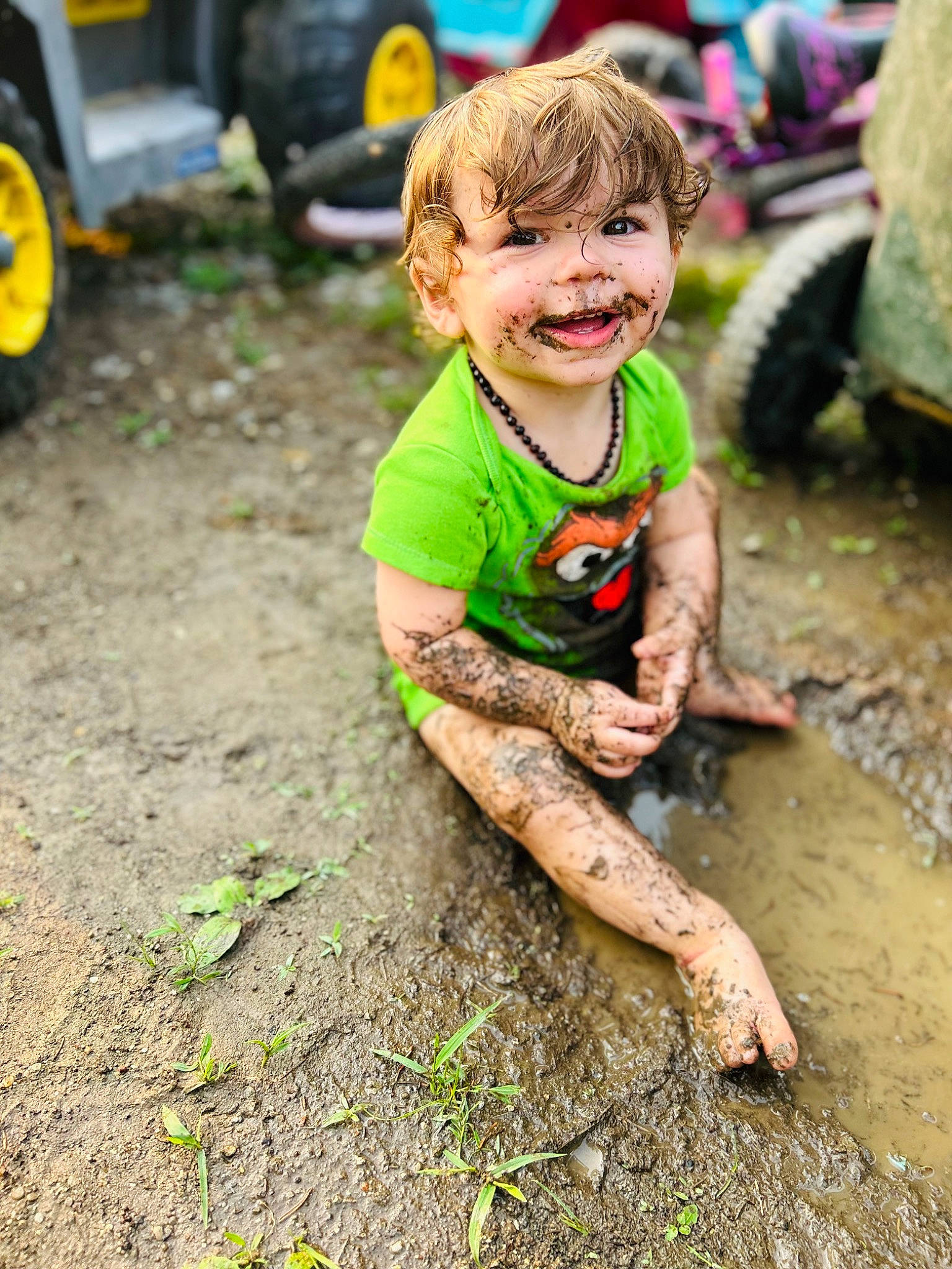 Bryer is registered to the contest to win money with this photo: asphalt, automotive_tire, child, fun, grass, happy, joy, leisure, people, people_in_nature, person, play, shorts, smile, soil, summer, t_shirt, tire, toddler, vehicle