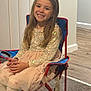 Nevaeh joined the competition — help win amazing prizes! child, girl, smiling, sequin_top, pink_skirt, folding_chair, indoor, wooden_floor, door, long_hair, happy, sitting, tights, patterned_tights, red_frame, blue_fabric, carpet, casual, portrait, home