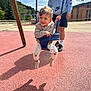 Nolan a rejoint le concours — aidez-le/la à gagner de superbes lots ! child, toddler, swing, playground, adult, smiling, outdoor, clothing, pants, socks, sneakers, person, sky, clouds, trees, building, shadow, daylight, fun, recreation