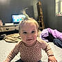 Delilah joined the competition — help win amazing prizes! baby, child, smiling, indoor, bed, blanket, clothing, person, cute, hair_tie, jeans, long_sleeve_shirt, furniture, living_room, window, wooden_ladder, television, cozy, happy, portrait