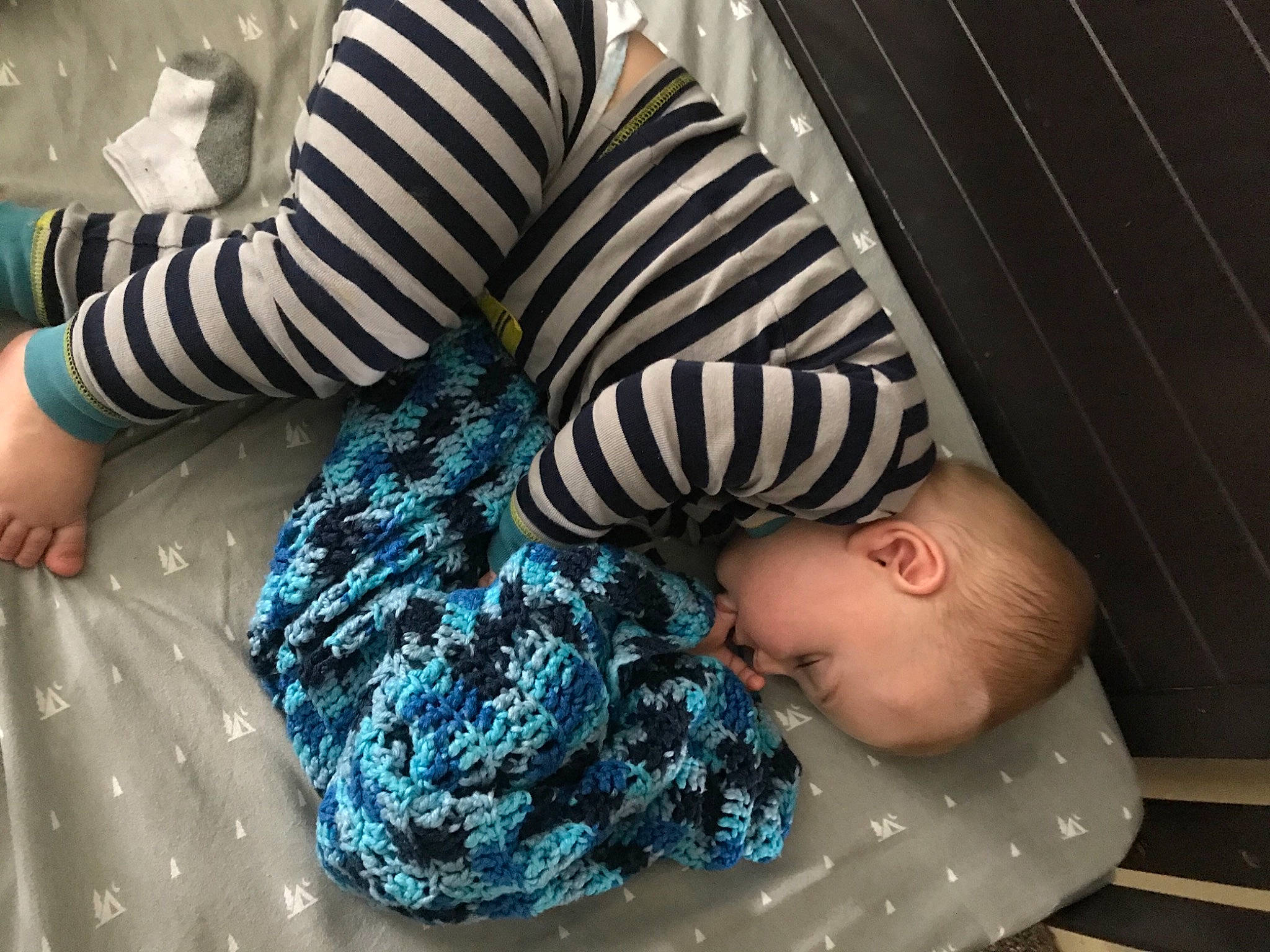 Bo is registered to the contest to win money with this photo: baby, baby_toddler_clothing, child, comfort, elbow, electric_blue, foot, fun, human_leg, pattern, person, sitting, sleeve, textile, thigh, toddler