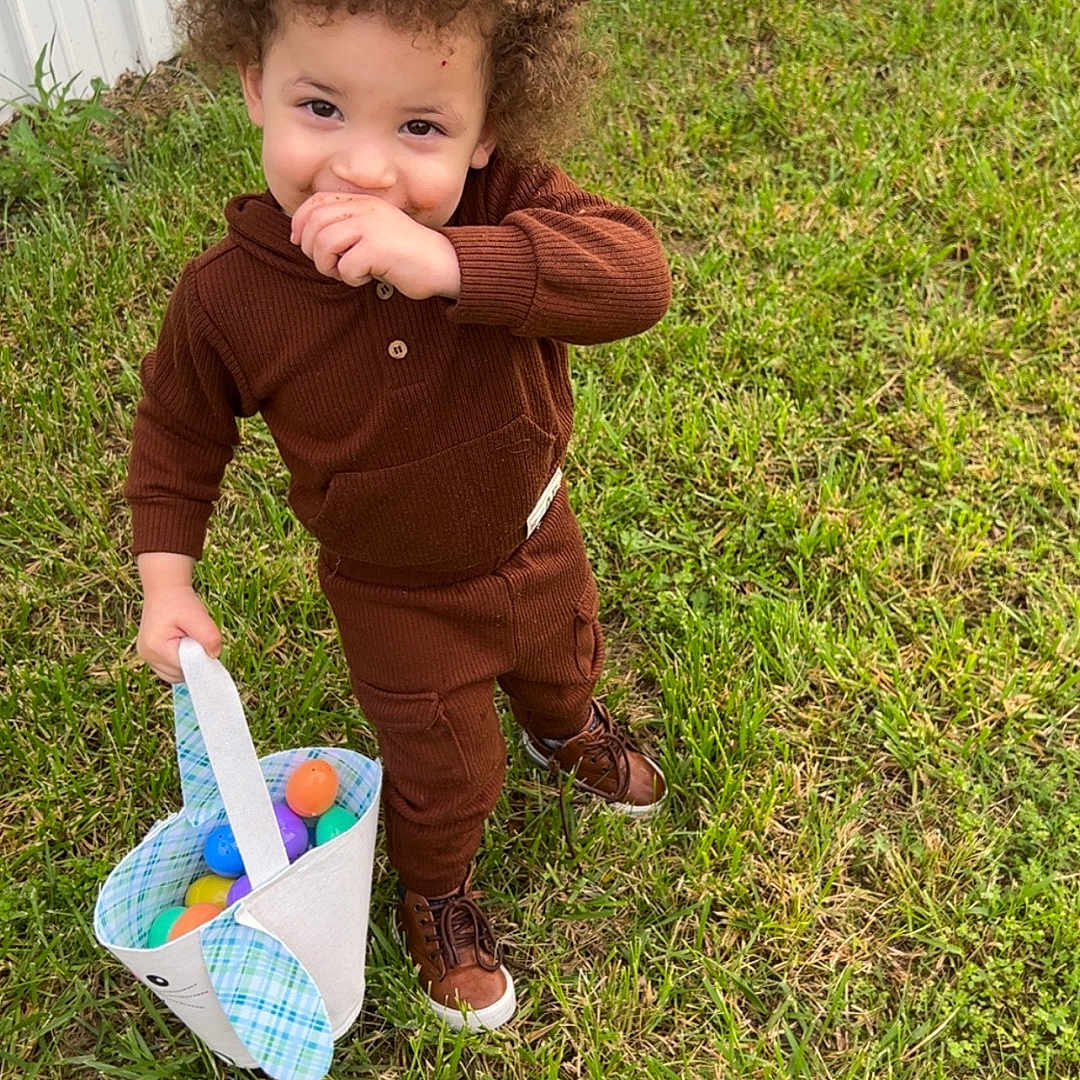 Kylann joined the competition — help win amazing prizes! basket, brown_clothing, bunny_basket, casual_wear, child, curly_hair, cute, grass, greenery, holiday, nature, outdoor, plastic_eggs, playful, portrait, shoes, shy, spring, standing, toddler