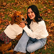 Annalee is registered to the contest to win money with this photo: woman, dog, autumn, leaves, grass, sweater, plaid_skirt, boots, smile, outdoor, fall, pet, cuddling, casual_clothing, nature, happy, portrait, sitting, animal, friendship