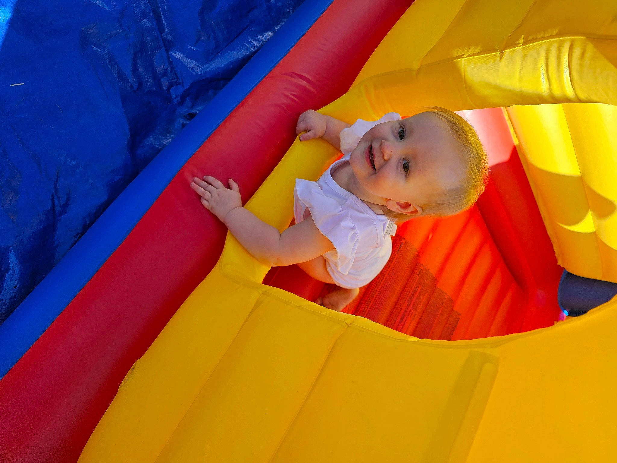 Ariella is registered to the contest to win money with this photo: baby, baby_toddler_clothing, blue, bounce_house, child, chute, comfort, electric_blue, fun, grass, happy, joy, leisure, outdoor_play_equipment, person, play, playground, recreation, smile, t_shirt