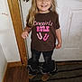 Davina joined the competition — help win amazing prizes! child, smiling, indoor, door, tshirt, text, jeans, boots, floor, carpet, wood, wall, blonde_hair, standing, happy, person, clothing, casual, young, cute