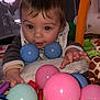 Kayden participe au concours pour gagner de l'argent avec cette photo : baby, child, playpen, toys, balls, colorful, indoor, curious, face, hand, giraffe_toy, duck_toy, blanket, fabric, infant, soft_toys, playtime, closeup, play_area, smiling
