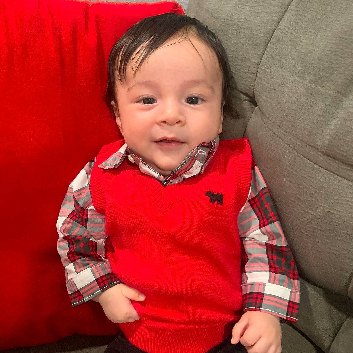 Eric is registered to the contest to win money with this photo: baby, baby_toddler_clothing, cheek, child, collar, comfort, eye, gesture, happy, nose, outerwear, pattern, person, plaid, sitting, sleeve, smile, t_shirt, textile, thumb