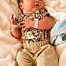 baby, bare_feet, blanket, camouflage, child, close_up, clothing, cozy, face, foot_tag, hospital, indoors, infant, lying_down, newborn, photography, portrait, shorts, sleeping, wristband