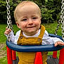 baby, chains, child, cute, daylight, face, fun, grass, greenery, happy, infant, nature, outdoor, playground, portrait, seat, smile, swing, white_shirt, yellow_overalls