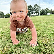 Theodore joined the competition — help win amazing prizes! toddler, child, grass, outdoor, crawling, smiling, blue_eyes, short_hair, mohawk, park, trees, soccer_goal, field, daylight, casual_clothing, cute, happy, person, nature, playful