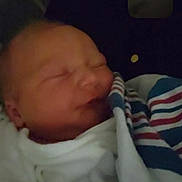 Mckenzie is registered to the contest to win money with this photo: newborn, baby, sleeping, blanket, hospital, person, infant, wrapped, soft, face, sleep, cozy, human, child, portrait, closeup, rest, peaceful, hands, dark