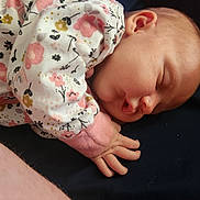 Mckenzie joined the competition — help win amazing prizes! baby, child, closeup, clothing, comfort, cozy, cute, face, floral_pattern, hand, infant, lying_down, newborn, peaceful, pink, portrait, rest, skin, sleeping, soft