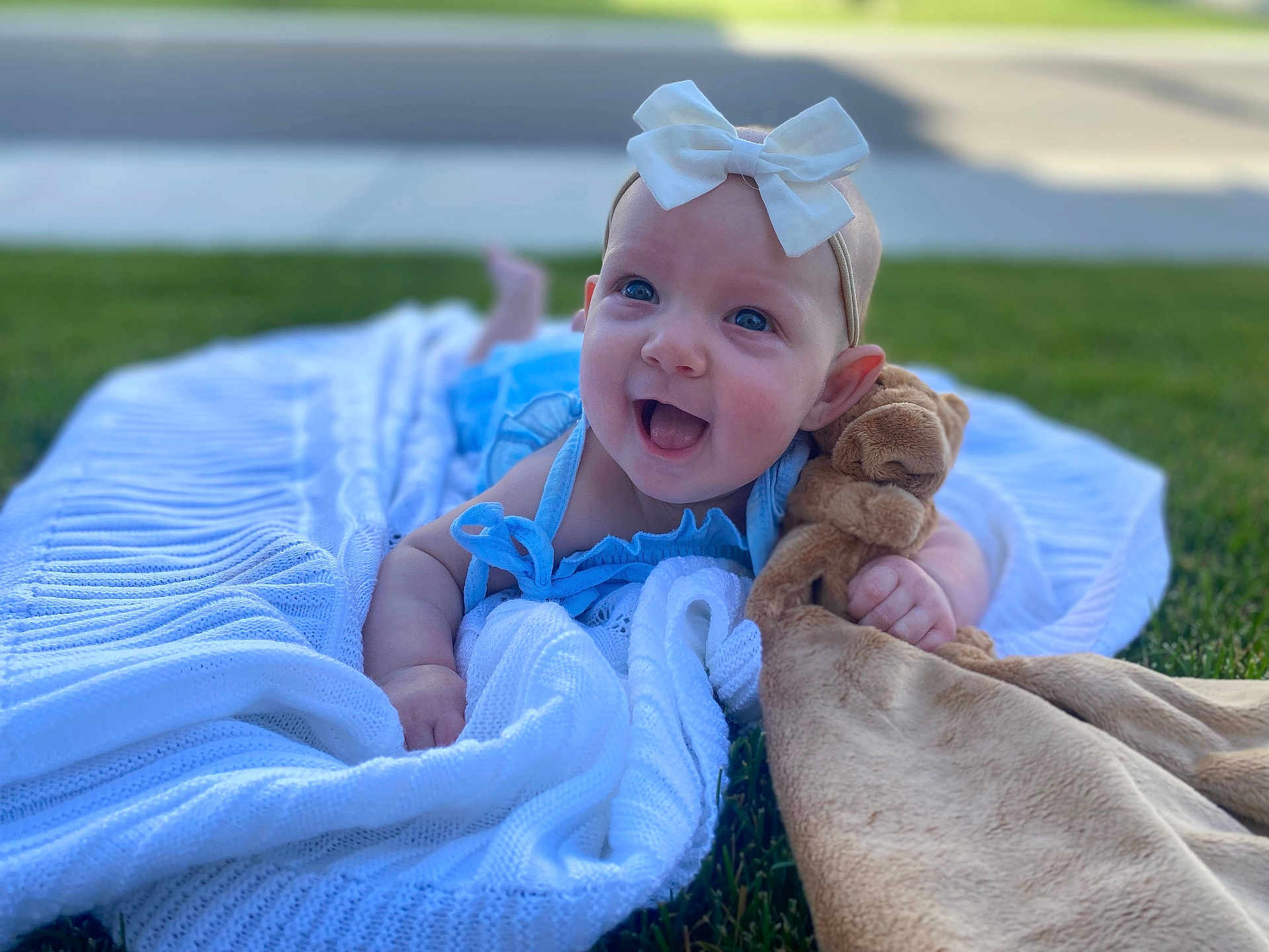 Cirilla joined the competition — help win amazing prizes! baby, child, smiling, bow, blue_dress, blanket, grass, outdoor, plush_toy, happy, cute, portrait, infant, headband, toy, lying_down, summer, daylight, face, skin