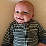 Elio a rejoint le concours — aidez-le/la à gagner de superbes lots ! baby, infant, smile, face, onesie, clothing, striped, hand, lying_down, portrait, cute, child, soft_background, happy, closeup, zipped, young, expression, skin, person