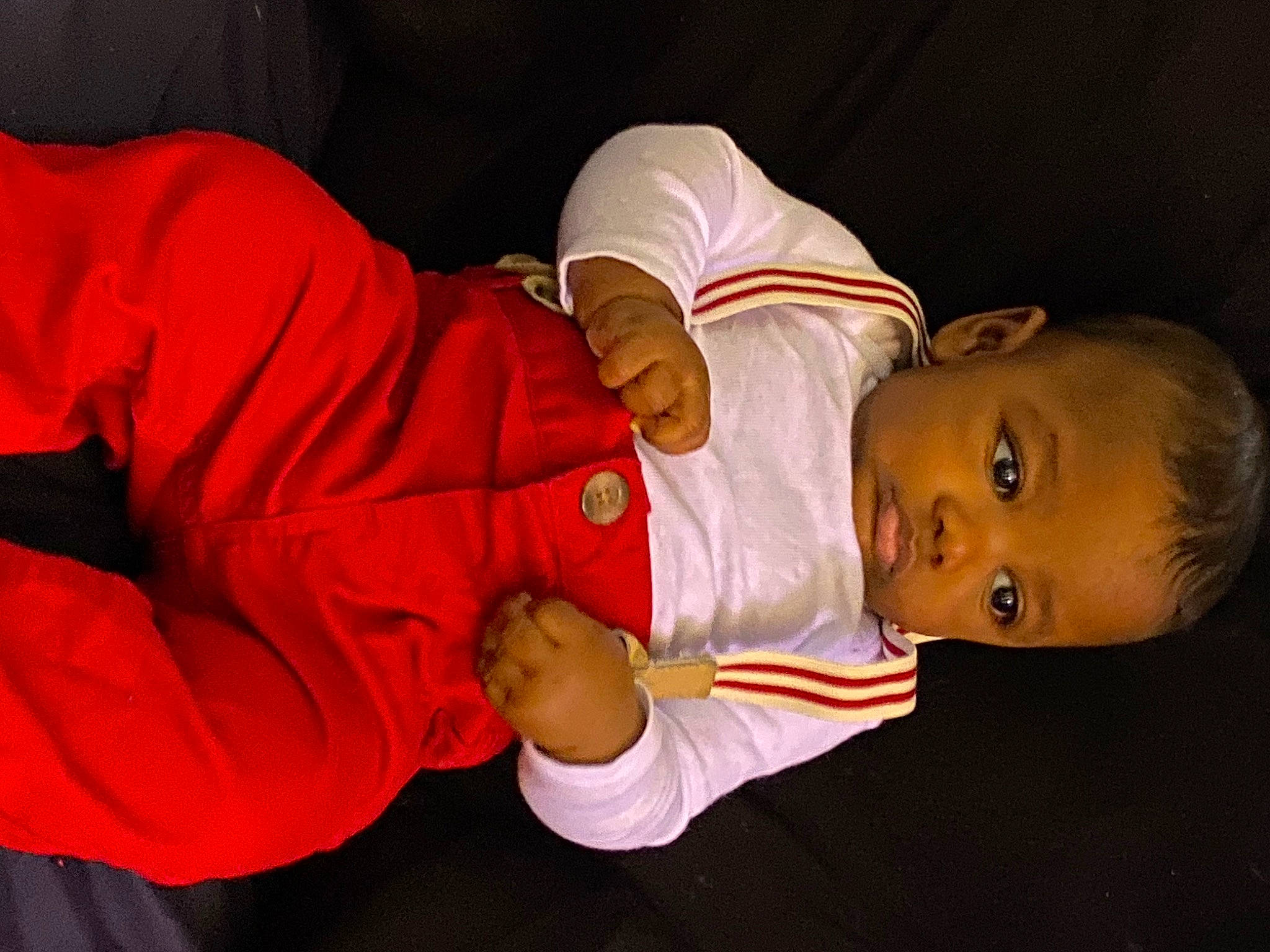 Wess is registered to the contest to win money with this photo: baby, baby_toddler_clothing, carmine, child, comfort, elbow, event, fun, gesture, hand, happy, human_body, nail, nose, person, room, sitting, sleeve, thumb, toddler