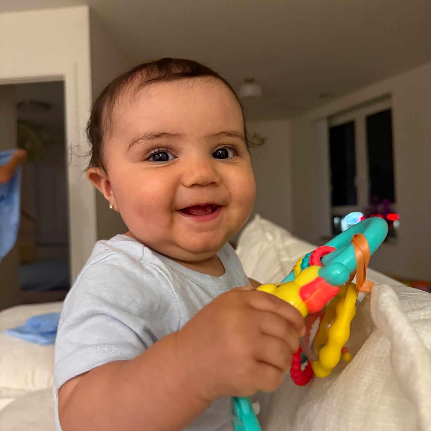Harlow joined the competition — help win amazing prizes! baby, child, smiling, toy, indoor, happy, person, cute, playful, young, infant, holding, colorful, face, portrait, toddler, clothing, home, couch, bright