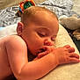 baby, sleeping, infant, thumb_sucking, cushion, blanket, toy, soft, indoor, closeup, peaceful, resting, child, skin, hand, face, head, nap, comfort, cozy