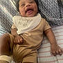 Noah joined the competition — help win amazing prizes! baby, infant, smiling, laughing, bib, clothing, bed, blanket, pattern, striped, cute, happy, child, person, skin, head, hand, foot, indoor, lying