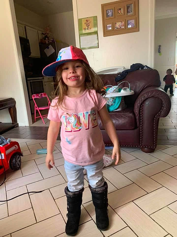 Catherine is registered to the contest to win money with this photo: blurred, cap, fashion_design, floor, flooring, fun, hairstyle, hat, headgear, headwear, joint, joy, person, picture_frame, product, shoe, shoulder, sleeve, smile, standing