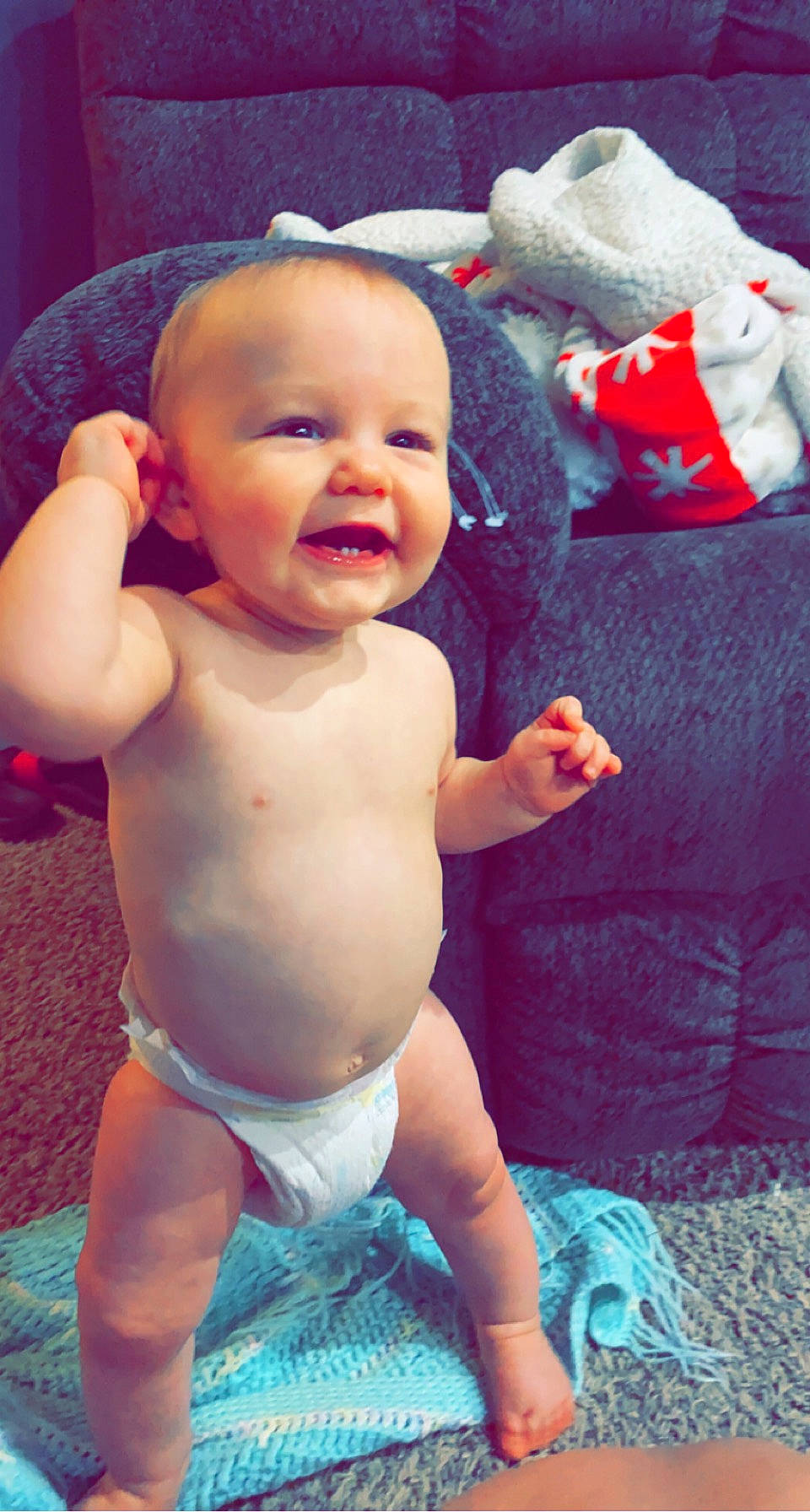 Keenan is registered to the contest to win money with this photo: arm, baby, baby_toddler_clothing, blue, cheek, face, facial_expression, finger, green, happy, head, human_body, iris, leg, mouth, muscle, person, pink, skin, smile
