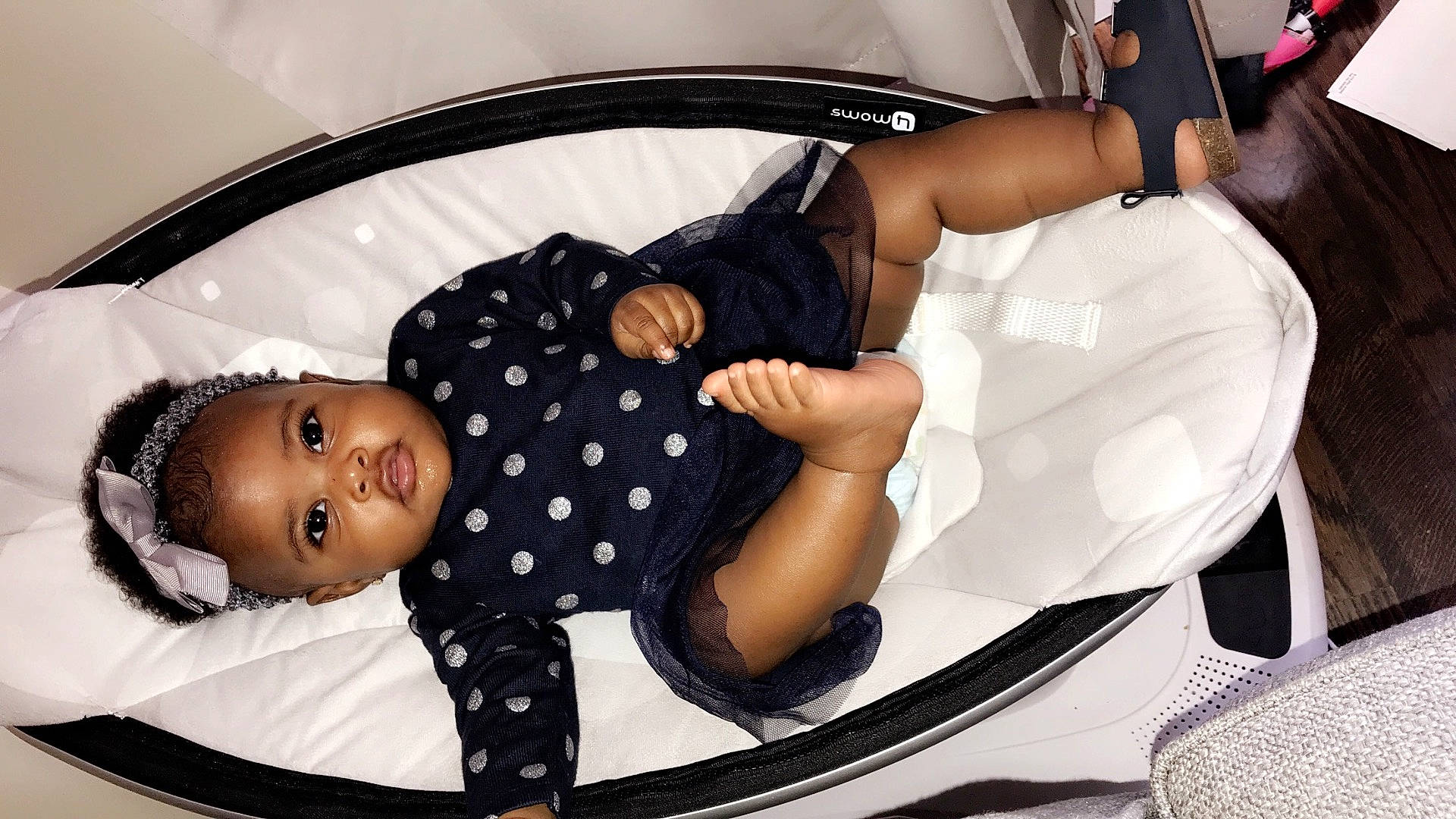 Kamea is registered to the contest to win money with this photo: baby_products, black_hair, car_seat, child, design, girl, hair_accessory, headgear, infant, pattern, person, product, sitting, toddler