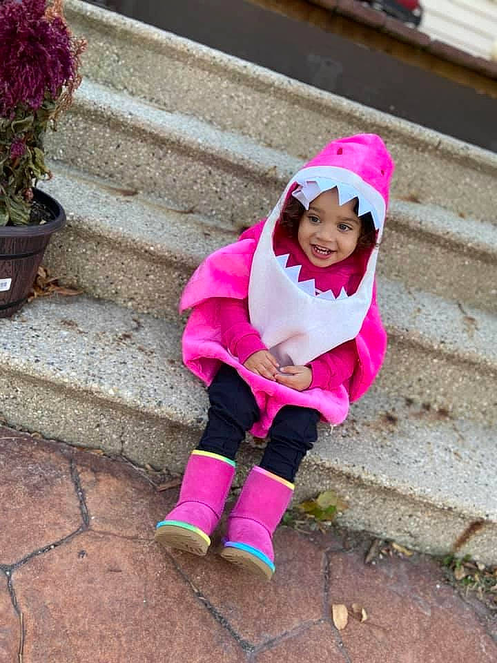 Amariana is registered to the contest to win money with this photo: baby_toddler_clothing, bonnet, boot, child, child_model, cobblestone, flagstone, flowerpot, headwear, hood, houseplant, joy, magenta, person, pink, purple, stairs, toddler, winter