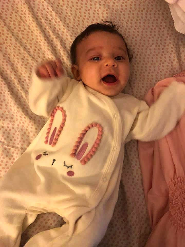 Amariana is registered to the contest to win money with this photo: baby, baby_products, baby_toddler_clothing, cheek, child, facial_expression, finger, laugh, linens, lip, nightwear, peach, person, skin, sleeve, textile, toddler, tongue