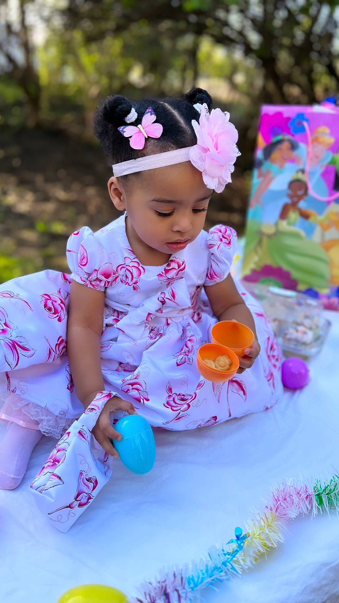Sarai joined the competition — help win amazing prizes! baby, baby_toddler_clothing, child, dress, event, flower, fun, grass, happy, hat, headwear, leisure, magenta, party_supply, person, petal, pink, purple, recreation, sitting