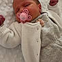 baby, newborn, pacifier, sleeping, blanket, knitted_cardigan, white_clothing, soft_texture, infant, cute, peaceful, resting, pink_pacifier, small_hands, portrait, indoors, cozy, child, toddler, sleep