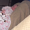 Jessica is registered to the contest to win money with this photo: baby, sleeping, blanket, stuffed_toy, cow_toy, quilt, bedroom, cozy, infant, child, indoors, peaceful, rest, soft_lighting, fabric, comfort, person, cute, nap, home