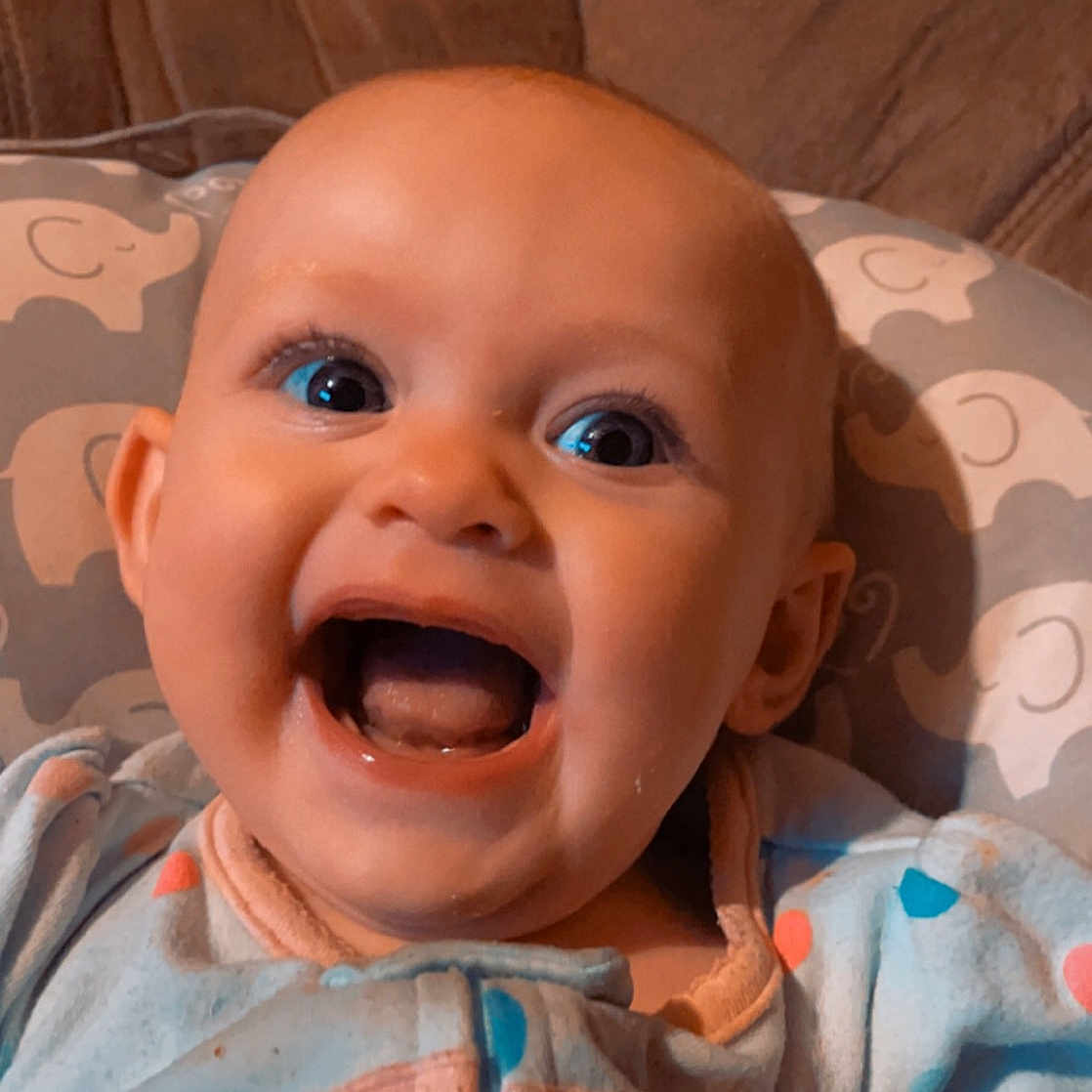 Oaklynn is registered to the contest to win money with this photo: baby, cheek, chin, eye, eyebrow, facial_expression, forehead, head, human_body, iris, lip, mouth, nose, orange, organ, skin, sleeve, smile, tooth, white